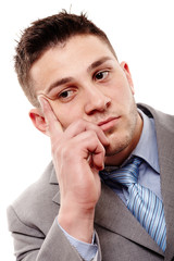 Pensive businessman with hand on chin