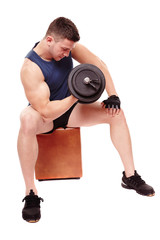 Handsome man working with heavy dumbbells