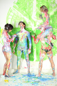 Four people in studio with whole body in the paint