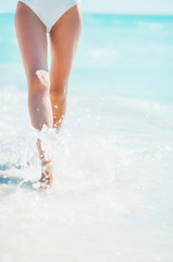 Closeup on young woman walking at seaside