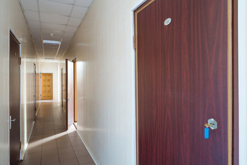 Corridor with an open door in office building