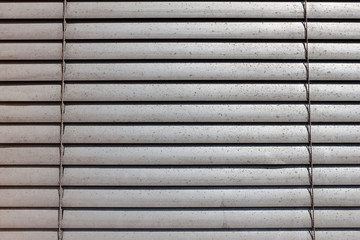 grey shutters over a shop window