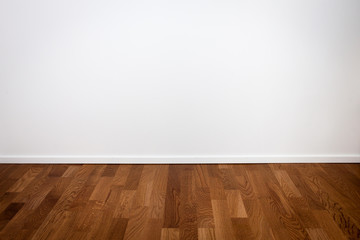 Naklejka premium Empty white wall and wooden floor