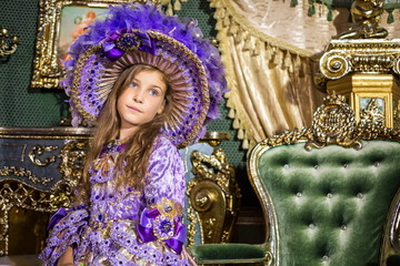 Obraz premium The little girl in dress and hat in beautiful room