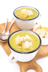 zucchini soup with croutons in a cups, isolated