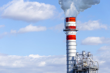 industrial smoke from chimney on blue sky