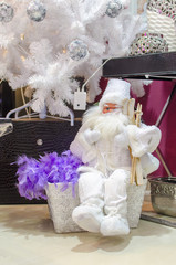 Santa Claus toy sitting under white pine tree