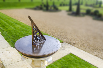 Old sun clock dial in a garden Kingston, London, UK