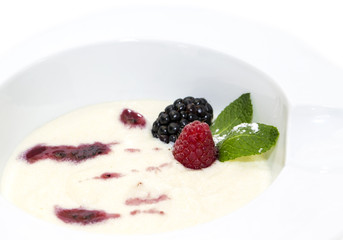 semolina porridge with berries decorated with berry jam