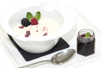 semolina porridge with berries decorated with berry jam
