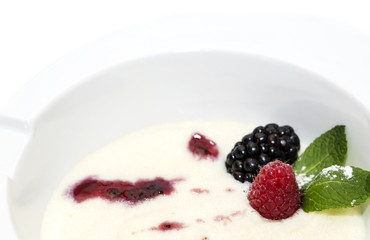 semolina porridge with berries decorated with berry jam