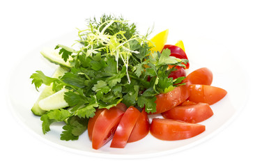 plate with fresh vegetables on a white background