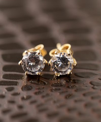 gold earrings stud with diamonds macro shot © Olga Kriger