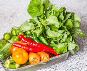 Mix tropical vegetables on a kitchen granite surface counter