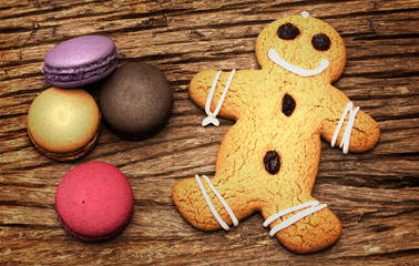 Macaron and ginger bread on the wood background