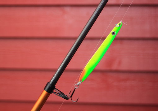 Green neon fishing hook on a fishing rod