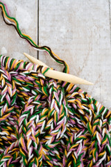 Knitting needles and yarn on wooden background