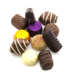 Assortment of fine chocolates in white, dark, and milk on a whit