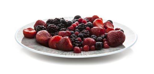 Plate of fresh fruit on a white background