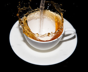 tea being poured into a saucer
