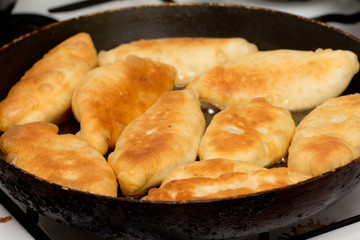 patties are fried in a pan