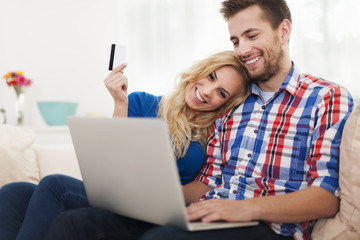 Young couple paying online by credit card