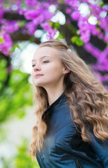 Romantic young girl with lilac in the background