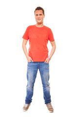 Young man guy red t-shirt jaens with hands in pockets isolated