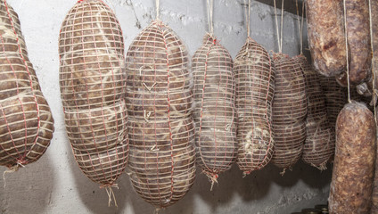 Salami Italian handmade hanging to mature in the cellar
