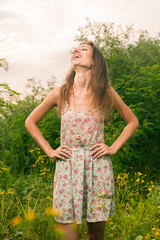 Beautiful Young Woman in Meadow of Flowers.