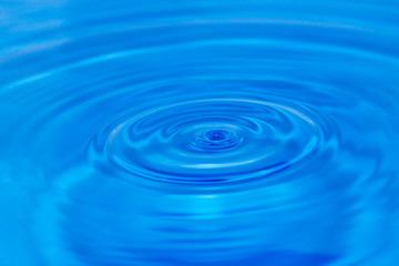 abstract background. drop falls in blue water