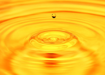 abstract background. A drop of water falls in gold