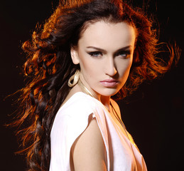 portrait of alluring woman over dark background