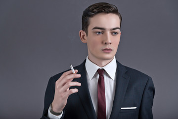 Retro fashion fifties young businessman wearing dark suit and ti