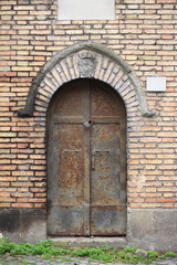 Medieval front door in Rome, Italy