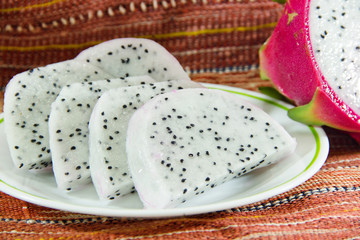 Dragon fruit slice in dish close up