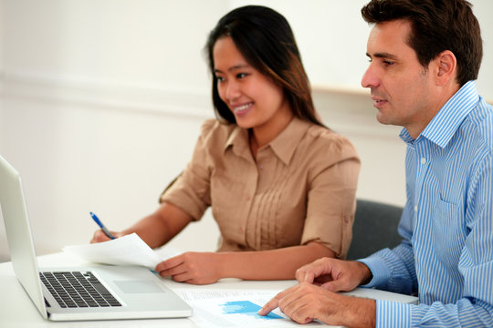 Male And Female Colleagues Working On Documents