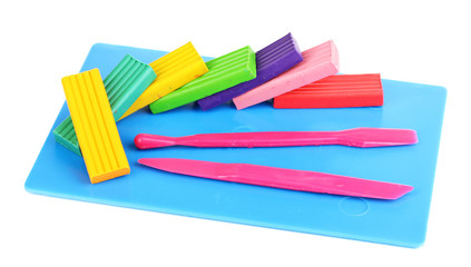 Obraz premium Children bright plasticine on desk with stacks isolated on