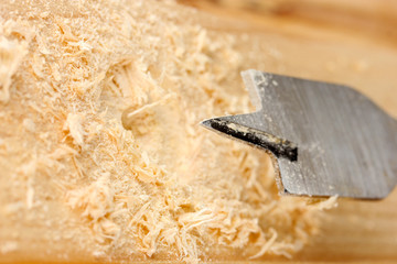 Close-up image of drilling hole on wooden plank