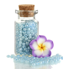 Little bottle full with colorful beads isolated on white