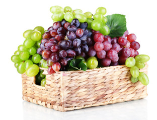 Ripe green and purple grapes in basket isolated on white