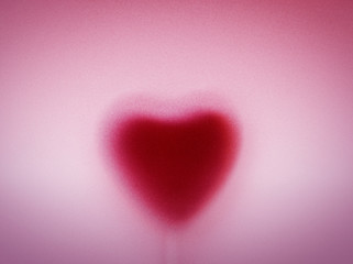 Heart shape behind milky frosted glass. Love background