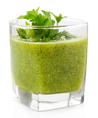 Glass of green vegetable juice isolated on white
