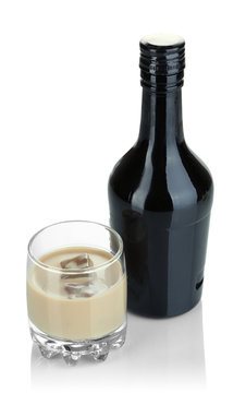Baileys liqueur in bottle and glass isolated on white