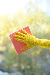 Hands with  napkin cleaning  window