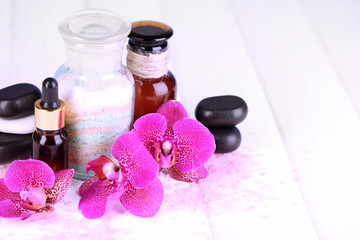 Beautiful spa setting with orchid on white wooden table