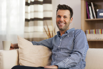 Smiling man with cup of coffee