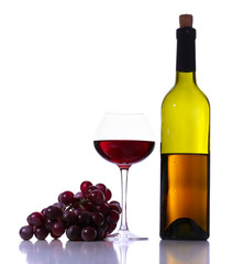 Wineglass with red wine, grape and bottle isolated on white