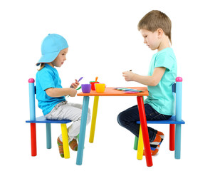 Little children playing with colorful tableware isolated