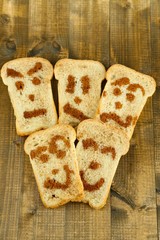 Funny toasts, on wooden background